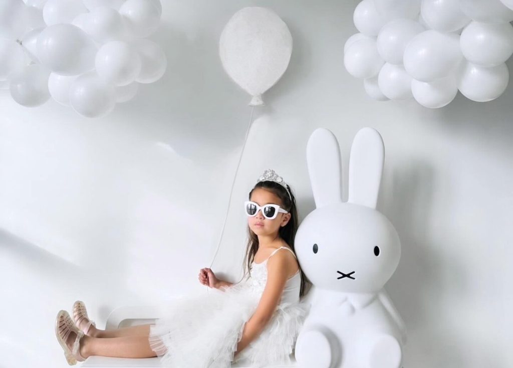 Girl leaning on a giant miffy lamp XL in childrens room