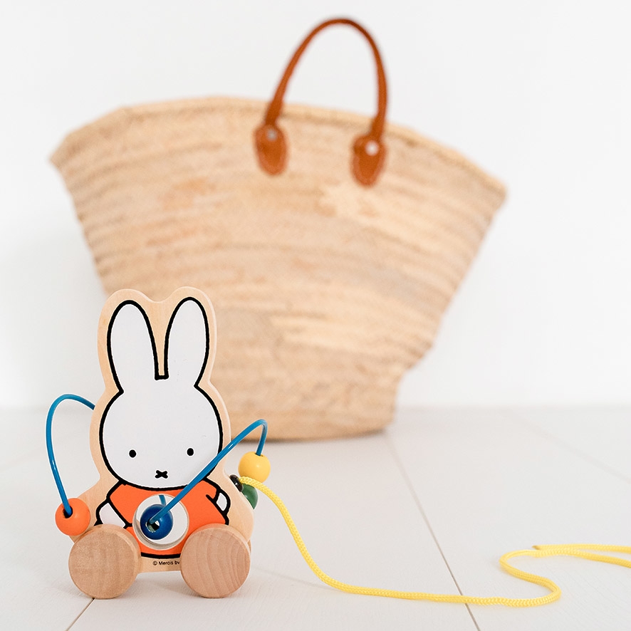 miffy pull toy in front of bag