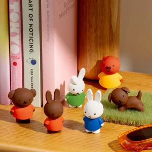 Miffy and friendsfigures on a shelf with books.