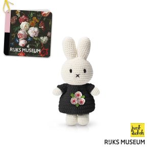 Knitted white Miffy rabbit in a black dress with a tulip pattern.