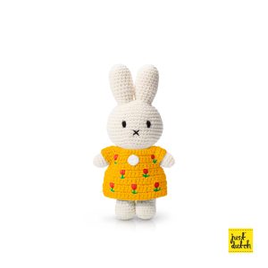 Knitted white Miffy rabbit in a yellow tulip-patterned dress.