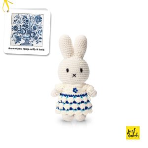 Knitted white Miffy rabbit in a white dress with a blue Delft-style floral pattern.