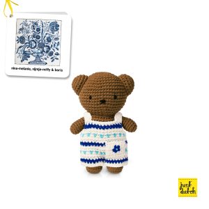 Knitted brown bear in a blue and white Delft-style patterned overall.