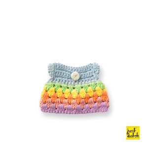 Knitted small handmade dress with a pastel rainbow stripe pattern in soft pink, yellow, green, and blue tones.
