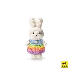 Knitted white Miffy rabbit in a pastel rainbow-striped dress with horizontal bands of soft pink, yellow, green, and blue.