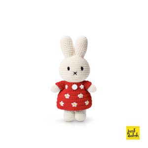 Knitted white Miffy rabbit in a red dress with a flower pattern.