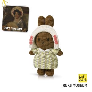 Knitted brown Melanie rabbit in a green outfit with patterns and earflap hat.