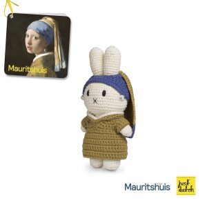 Knitted white Miffy rabbit in an olive green outfit with a blue knit hat.