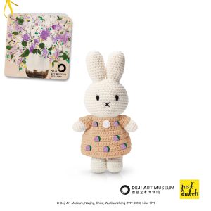 Knitted white Miffy rabbit in a light brown outfit with purple floral print.