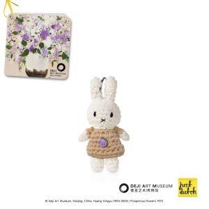 Knitted white Miffy rabbit keychain in a light brown outfit with purple floral print.