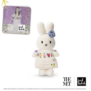 Knitted white Miffy rabbit in a light-colored outfit with subtle flowers.