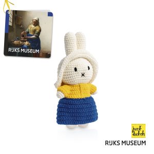 Knitted white Miffy rabbit dressed in a white milkmaid outfit with a blue apron, yellow shirt and white cap.