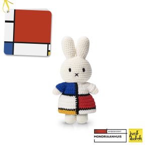Knitted white Miffy rabbit in a dress with a grid pattern of red, yellow, blue, and white rectangular blocks in the style of Mondrian.