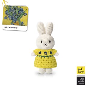 Knitted white Miffy rabbit in a yellow dress with blue flowers.