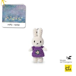 Knitted white Miffy rabbit keychain in a purple knitted dress with a flower.