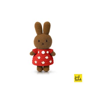 Brown knitted rabbit figure wearing a red tulip-patterned dress.