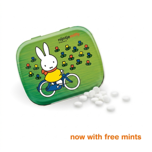 Green square metal tin with a Miffy illustration and small decorative icons, displayed with scattered white mint candies.