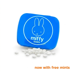 Blue square metal tin with a white Miffy illustration on the lid, shown with several small white mint candies in front.