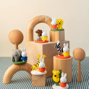 Assorted small white Miffy rabbit and character figurines arranged on display stands